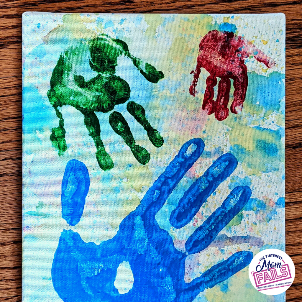 bubble paint toddler activity with hand prints on canvas